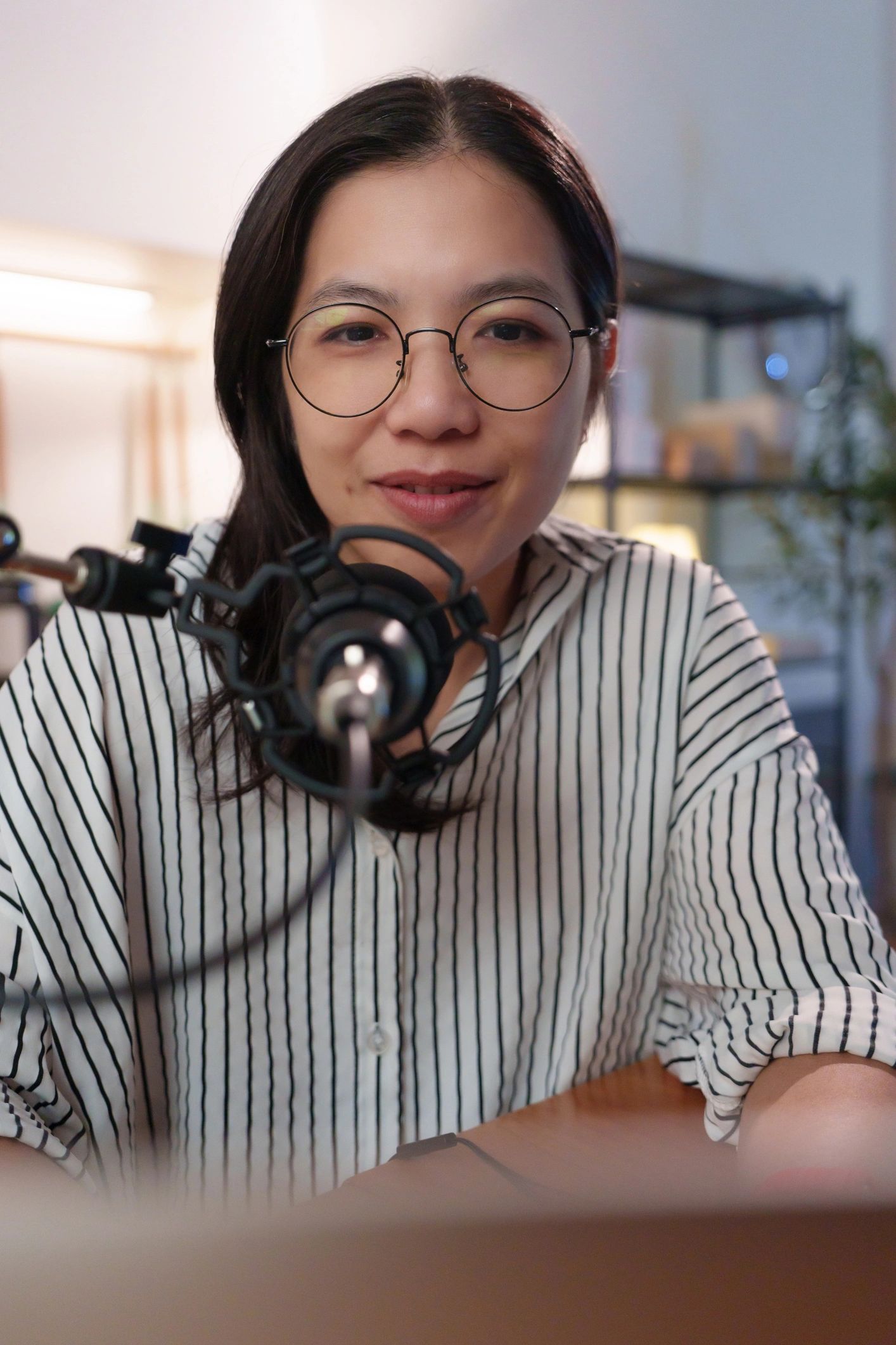 Podcast creator recording audio in a home studio